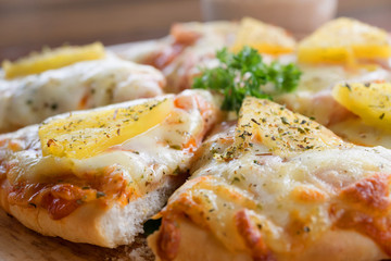 close up of Hawaiian pizza juicy pineapple chunks ham bits melted mozzarella cheese