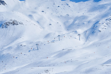 Fototapeta na wymiar Panoramic view of ski chair lift in high mountains in Switzerland