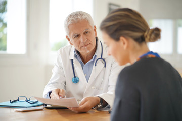 Doctor talking to patient in office