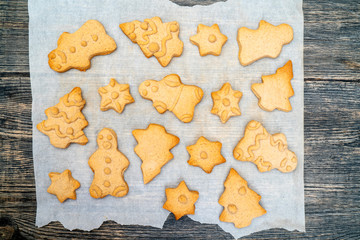 Gingerbread Cookies Christmas figures from dough, baked in the oven. On baking paper. The concept of Christmas meals.