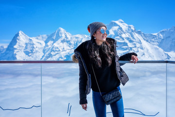 Young Woman Tourist at Schilthorn in Switzerland with a magnificent panoramic view of the Swiss...