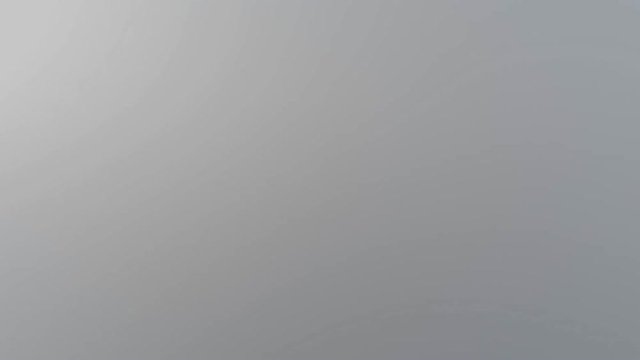 Aerial view moving through mysterious plumes of dense cloudy fog.