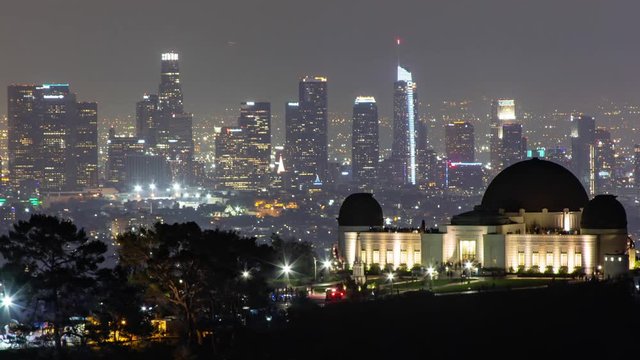 Los Angeles Downtown Skyline at Night with Griffith Observatory in the foreground. A Stunning Time Lapse