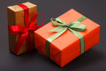 Gift boxes tied with ribbons on black background.