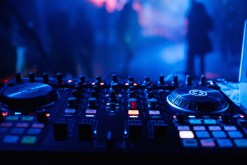 DJ mixer for mixing music and sound in a nightclub at a party