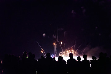 Fototapeta na wymiar Crowd watching fireworks and celebrating new year