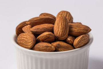 Almonds in white bowl.
