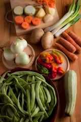 Ingredients to prepare vegan or vegetarian food, healthy food for vegan or vegetarian people, potatoes, carrots, onions, chili, beans, chives, zucchini, raw vegetables to prepare food