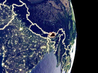 Satellite view of Bhutan at night with visible bright city lights. Extremely fine detail of the plastic planet surface.
