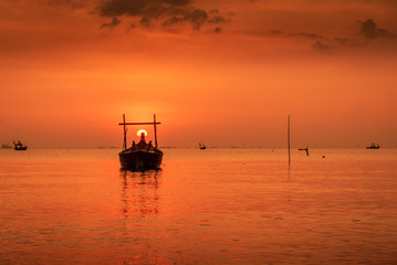 Fototapeta premium Landscape on the beach with wooden fishing boat and sunset twilight.