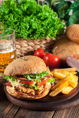 Chickenburger with bacon, tomato, cheese and lettuce