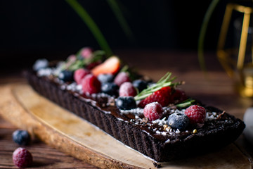 Rectangular Tart Chocolate cheesecake with fresh berries. delicious dessert for celebrate.