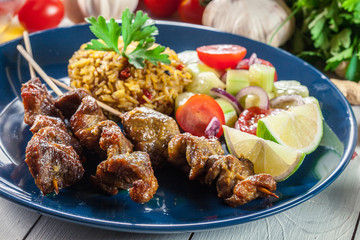 Traditional pork satay with peanut sauce and vegetables