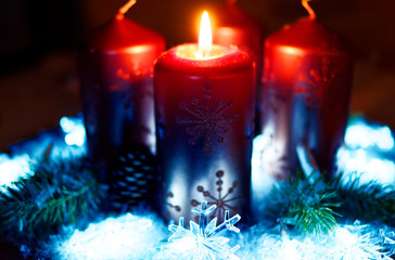 Advent wreath in red gold candles with snow as background and not yet lit candles