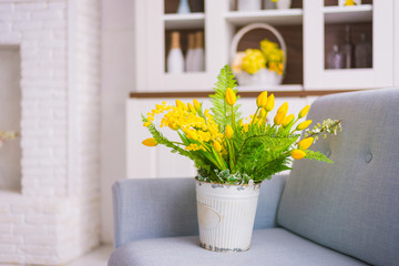 yellow floral decor placed on the couch