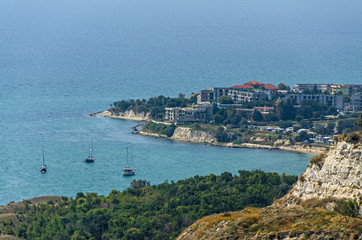 Fototapeta na wymiar Green Thracian cliffs near blue clear water of Black Sea, golf boats, rocky path seaview