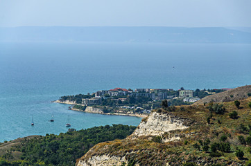 Green Thracian cliffs near blue clear water of Black Sea, golf boats, rocky path seaview