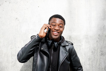 happy young black man talking on mobile phone