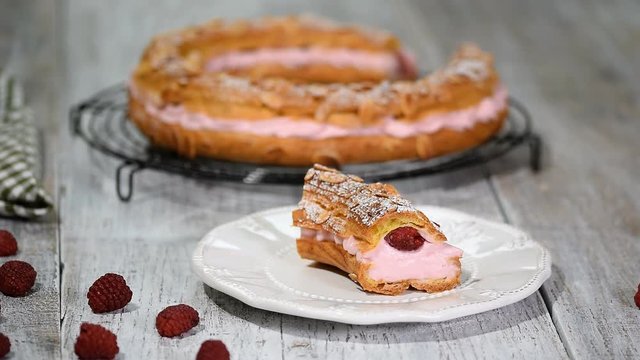 Homemade choux pastry cake Paris Brest with raspberries, almond, sugar powder. French dessert.