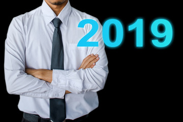 Businessman wearing necktie arm crossed on drak background.metaphor to business in development, success, entrepreneur or employment and advertising happy new year 2019 image.