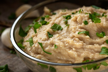 Homemade spread made from mashed boiled beans, oil and garlic in bowl