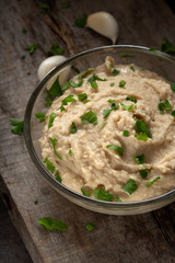 Homemade spread made from mashed boiled beans, oil and garlic in bowl