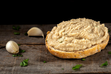Open sandwich with smashed boiled beans mixed with garlic