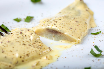 Marinated mackerel fillet with mayonnaise and herbs on white plate