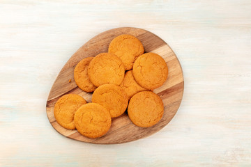 A photo of ginger cookies on rustic textures, shot from the top with a place for text