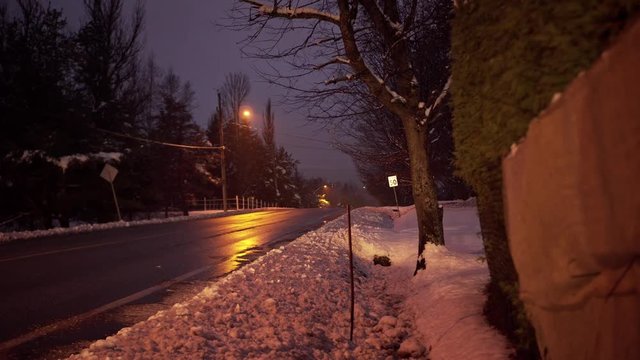 Cars passing on a street at night