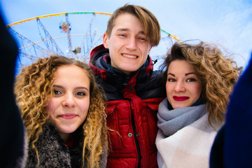a group of friends do selfie in the winter in a clearing