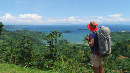Woman hiker looking the Kivu lake in Rwanda. view of the landscape in Rwanda with woman