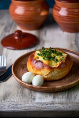 Bread bowls stuffed with mushrooms, chicken meat, cheese and bolognese sauce for lunch. Julienne in a bun, creative burger idea