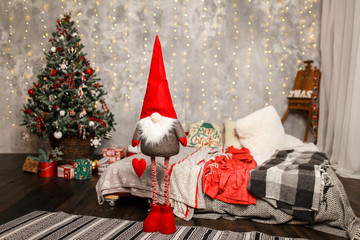 Christmas gnome near the Christmas tree at home
