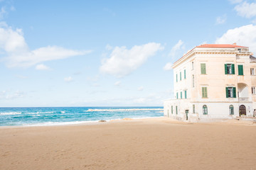 Beach and Building on the southern Italian Mediterranean Coast on a Sunny Day