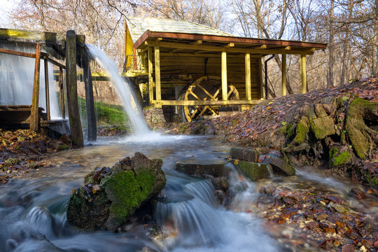 A stream of flowing clean spring water in an old mill. Photo taken in autumn in Russia.