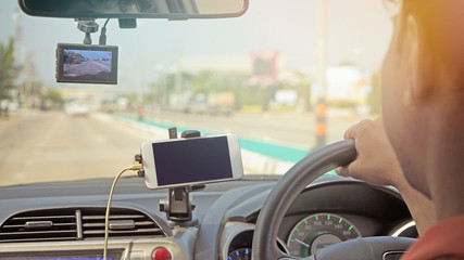  Man driving car .HE using smartphone and navigate in cars        