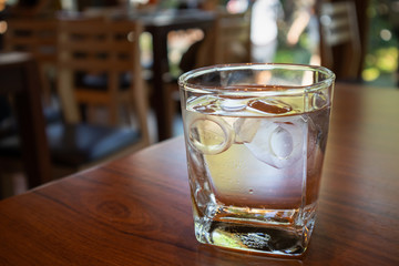 glass of water on wood table in restaurant