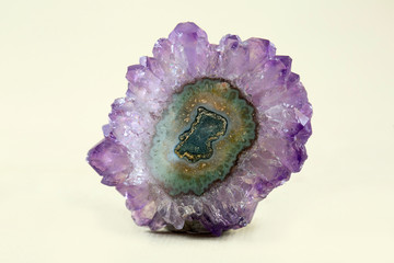 A banded Agate specimen with a geode of Quartz crystals