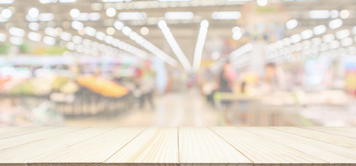 Wood table top with supermarket grocery store blurred defocused panorama background with bokeh light for product display