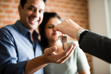 Cheerful couple with keys to their new home