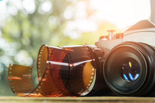 Vintage camera with film roll on the ground. Travel background