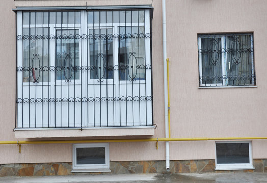 Metal grid for window and balcony protection. House flat balcony window with iron security bars.