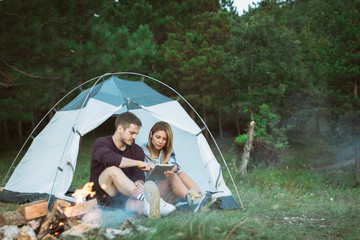 Young man and woman looking for direction on digital tablet 