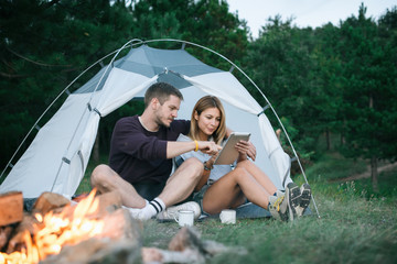 Young man and woman looking for direction on digital tablet 