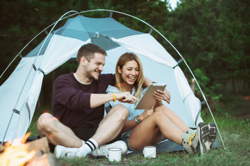 Young man and woman looking for direction on digital tablet 