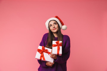 Cheerful young girl wearing red santa hat