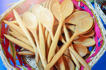 many wooden spoons in the basket