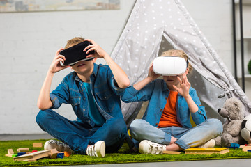 little children using virtual reality headsets near wigwam at home © LIGHTFIELD STUDIOS