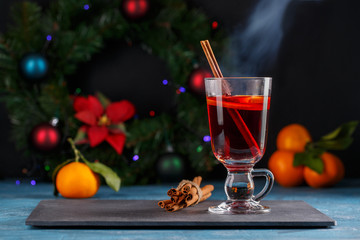 Mulled wine in glass mug. Hot red wine with fruits and spices.